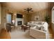 Warm living room with fireplace, neutral sectional sofa, and wood-paneled walls at 2646 Jacobs Rd, Gastonia, NC 28054