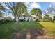 View of the home and large yard from the backyard surrounded by mature trees at 2679 Providence Mill Rd, Maiden, NC 28650