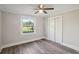 Bedroom with a ceiling fan, closet, and a window providing natural light and a backyard view at 2679 Providence Mill Rd, Maiden, NC 28650
