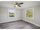 Bright bedroom with hardwood flooring, with windows offering backyard views and natural light at 2679 Providence Mill Rd, Maiden, NC 28650