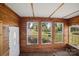 Cozy sunroom with wood paneled walls and large windows at 2679 Providence Mill Rd, Maiden, NC 28650