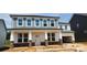 New two-story home with stone accents and covered front porch, enhancing curb appeal at 277 Supernova Dr # 12, York, SC 29745