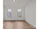 Bright bedroom with hardwood floors and natural light from two windows at 277 Supernova Dr, York, SC 29745