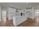 A modern kitchen with white cabinets, stainless steel appliances, and a large center island at 277 Supernova Dr, York, SC 29745