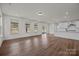 Open-concept living space featuring hardwood floors and a modern kitchen with white cabinets at 277 Supernova Dr, York, SC 29745