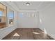 Bright living room with hardwood floors, tray ceiling, and multiple windows providing natural light at 277 Supernova Dr, York, SC 29745