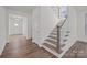 An entryway staircase showcasing natural wood steps with white risers at 277 Supernova Dr, York, SC 29745