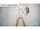 Bright entryway featuring hardwood floors and a decorative front door at 3023 Sassafras Trl, Gastonia, NC 28056
