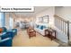 Open-concept living room adjacent to the kitchen, featuring a comfortable sofa and staircase at 3023 Sassafras Trl, Gastonia, NC 28056