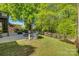 Lush backyard with a patio area, fire pit, and mature trees offering shade at 3040 Sunshower Hts, York, SC 29745