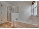 Bathroom with a large soaking tub, separate glass-enclosed shower, and a window at 3040 Sunshower Hts, York, SC 29745
