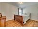 A cozy bedroom with a wooden bed frame, window view and wood flooring at 3040 Sunshower Hts, York, SC 29745