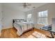 Bright bedroom featuring wood floors, two windows, and a ceiling fan at 3040 Sunshower Hts, York, SC 29745