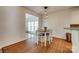Charming dining area featuring a wooden table, white chairs, and modern pendant lighting at 3040 Sunshower Hts, York, SC 29745
