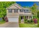 Charming two-story home features a two-car garage and a beautifully landscaped front yard at 3040 Sunshower Hts, York, SC 29745