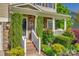 The beautiful front porch has stone accents, brick steps, and lush, mature landscaping at 3040 Sunshower Hts, York, SC 29745
