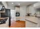 The kitchen has granite countertops, white cabinetry, hardwood flooring, and stainless appliances at 3040 Sunshower Hts, York, SC 29745
