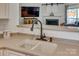 A close-up of a sink and faucet in a well-lit kitchen with open floor plan at 3040 Sunshower Hts, York, SC 29745