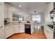 Bright kitchen featuring white cabinetry, black appliances, and a seamless transition to the dining area at 3040 Sunshower Hts, York, SC 29745