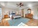 Bright main bedroom with tray ceiling, wood floors, four-poster bed, dresser, and bench at 3040 Sunshower Hts, York, SC 29745