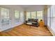 Cozy sunroom with many windows, a comfortable sofa, and hardwood floors at 3040 Sunshower Hts, York, SC 29745
