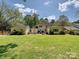 Wide view of sprawling backyard with expansive lawn and partial patio, perfect for entertaining at 3324 Champaign St, Charlotte, NC 28210