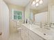 Bathroom featuring a double sink vanity, a large mirror, and a shower with a curtain at 3324 Champaign St, Charlotte, NC 28210