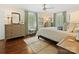 Bright bedroom with hardwood floors, area rug, neutral colors, ceiling fan and ample natural light at 3324 Champaign St, Charlotte, NC 28210