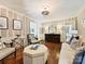 Cozy living room with hardwood floors, decorative wallpaper, an octagonal ottoman, and traditional furnishings at 3324 Champaign St, Charlotte, NC 28210