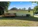 Spacious backyard featuring a wooden deck, a well-maintained lawn, and mature trees at 3423 Archer Ave, Charlotte, NC 28217