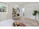 Bedroom featuring large window, ample storage, and neutral decor with a cozy aesthetic at 3423 Archer Ave, Charlotte, NC 28217