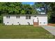 Charming single-story home features a fresh white paint, brick steps, and lush lawn at 3423 Archer Ave, Charlotte, NC 28217