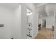 Hallway leading to powder room with modern vanity and fixtures, with hardwood flooring throughout at 3423 Archer Ave, Charlotte, NC 28217