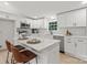 Bright kitchen with white cabinets, stainless steel appliances, and island with quartz countertop at 3423 Archer Ave, Charlotte, NC 28217