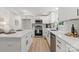Bright kitchen featuring white cabinets, stainless steel appliances, and a quartz countertop island at 3423 Archer Ave, Charlotte, NC 28217