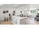 Modern open-concept living space featuring kitchen island, living room, and dining area at 3423 Archer Ave, Charlotte, NC 28217