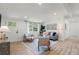 Bright living room features a cozy seating area, hardwood floors, and natural light at 3423 Archer Ave, Charlotte, NC 28217