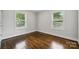 Sun-filled bedroom with two large windows and gleaming hardwood floors at 3725 Dunwoody Dr, Charlotte, NC 28215