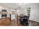 Bright dining area features modern lighting, hardwood floors and a view of the kitchen through a sliding barn door at 3725 Dunwoody Dr, Charlotte, NC 28215