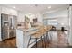 Bright kitchen with granite countertops, stainless steel appliances, and bar seating at 3725 Dunwoody Dr, Charlotte, NC 28215