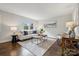 Comfortable living room featuring hardwood floors, natural light, stylish decor and a cozy seating arrangement at 3725 Dunwoody Dr, Charlotte, NC 28215