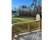 Spacious backyard with lush lawn, mature trees, storage shed, and view of the home from a wood deck at 4476 River Rd, Stanfield, NC 28163