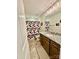 Bathroom with patterned shower curtain, granite counters, and tile floor at 4476 River Rd, Stanfield, NC 28163