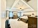 Bright bedroom with neutral walls, a large window, and a decorative mirror above a wooden dresser at 4476 River Rd, Stanfield, NC 28163