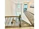 Grand foyer featuring a staircase with iron railings, chandelier, and natural light at 4476 River Rd, Stanfield, NC 28163
