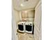 Well-organized laundry room featuring a modern washer and dryer, along with overhead cabinets at 4476 River Rd, Stanfield, NC 28163