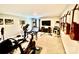 Spacious recreation room featuring exercise equipment, entertainment area, and guitars on the wall at 4476 River Rd, Stanfield, NC 28163
