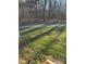 Yard features bright-green grass, trees in the background, and a gravel path at 4476 River Rd, Stanfield, NC 28163