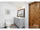 Bathroom features a double vanity, toilet, stylish barn door and decorative light fixture at 58 Ridgeport Rd, Clover, SC 29710