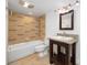Bathroom featuring a tiled shower-tub combo, dark vanity with granite countertops and framed mirror at 58 Ridgeport Rd, Clover, SC 29710
